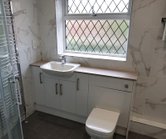 Small toilet area fitter with a new toilet and basin